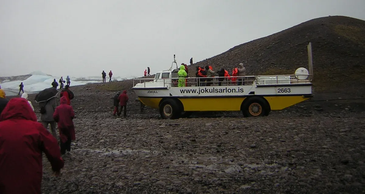 Passengers boarding a yellow amphibian boat on the shore for a Jökulsárlón glacier lagoon boat tour