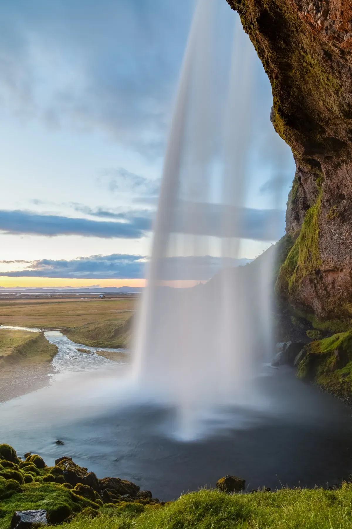 Seljalandsfoss waterfall seen from behind, a stop on a glacier lagoon boat tour day trip